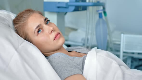 Young Female Patient Lying in a Hospital Room