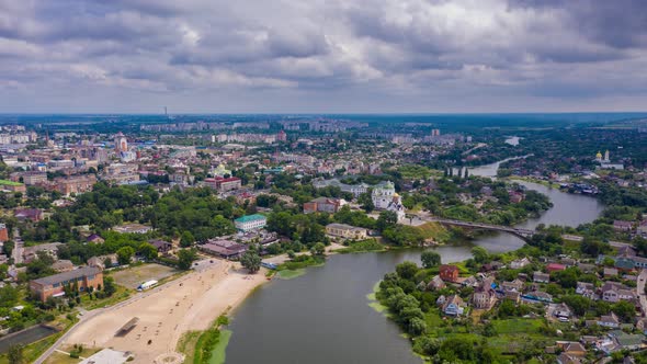 Nice top view of the city. Hyperlapse from a quadcopter. River, beach, buildings, cars are driving