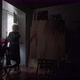 A Middle Aged Woman Artist in a Dark Room of the Gallery Opens a Window - VideoHive Item for Sale