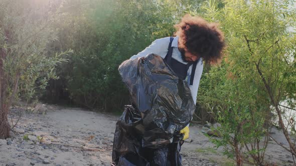 PickingUp and Packing Plastic Garbage in Refuse Sack