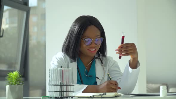 Female African Scientist Doctor Doing Blood Test in Laboratory. Covid 19 Test