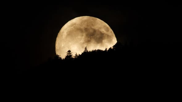 Moon with Clouds at Night Sky Over Mountain Forest Mystical and Mystery Huge Moon Nature Timelapse