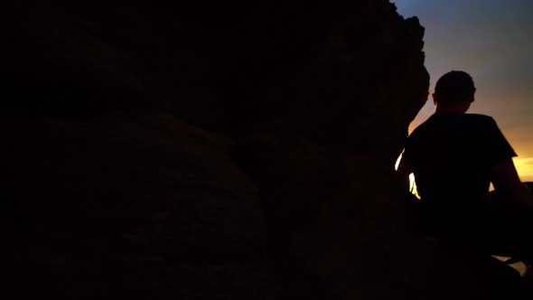 Man Watching Sunrise From Mountains