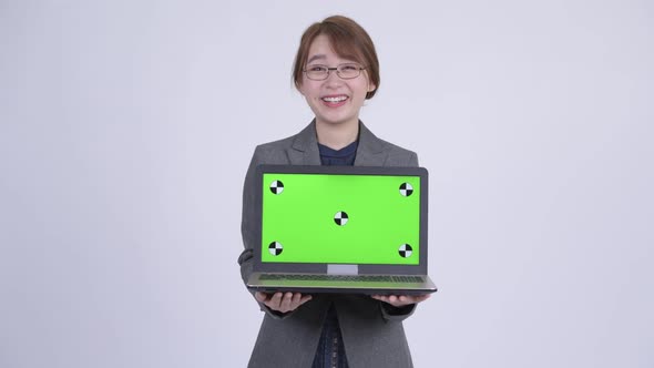 Young Happy Asian Businesswoman Showing Laptop and Looking Surprised