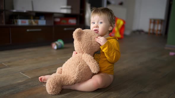 Portrait of Cute Little One Year Old Girl Laughing Happily While Playing and Hugging with Her Mother