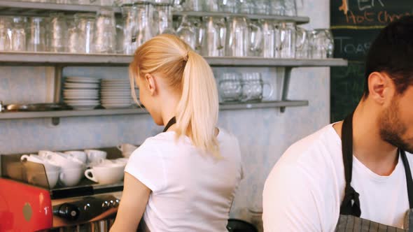 Waiter and waitress interacting while working