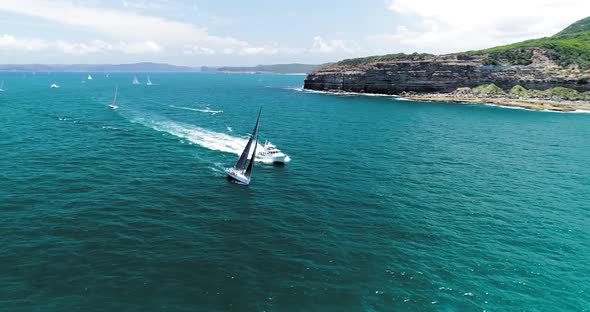 Slow orbiting aerial shot of a sail boat traveling at speed.