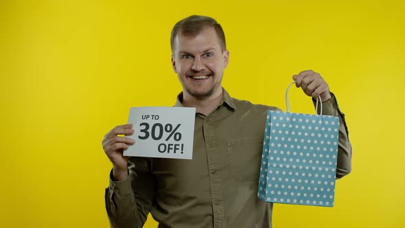 Man Showing Up To 30 Percent Off Inscription From Shopping Bag, Rejoicing Discounts, Low Prices