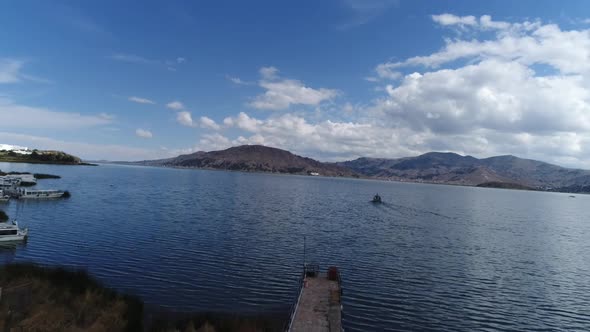 drone movement in the city of Puno on a beautiful sunny day over Titicaca lake, Peru