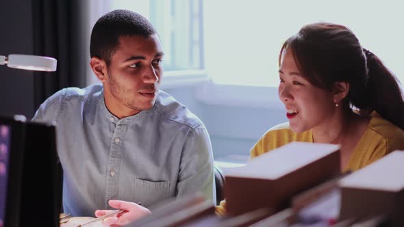 Two young people talking in the office