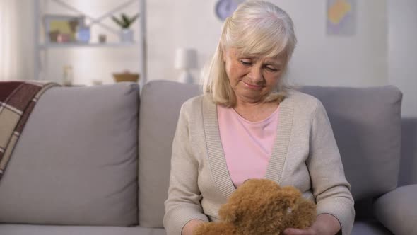 Sad Old Woman Hugging Toy Teddy-Bear, Missing Grandchildren, Long Separation