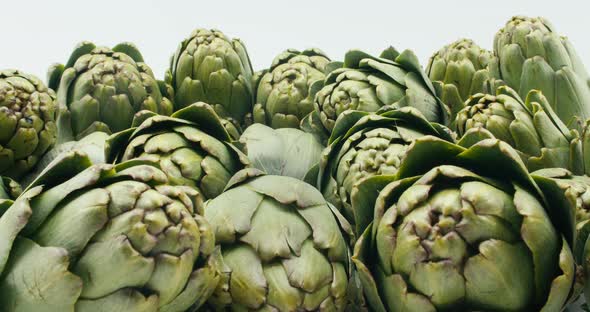 Pushing Camera in on Green Artichokes on White Background