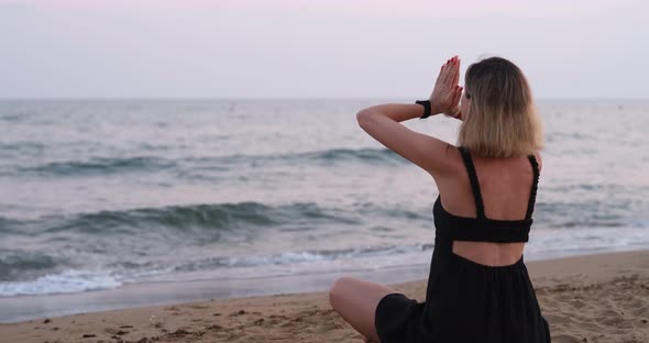 A Woman Meditates on the Seashore View From the Back