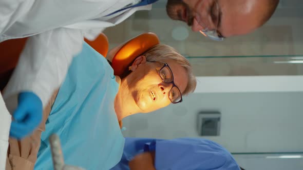 Vertical Video Orthodontist Lighting the Lamp Until Examination