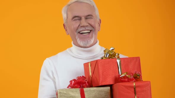 Glad Senior Male Holding Present Boxes in Hands, Holiday Preparation, Surprise