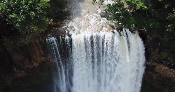 Drone moving backwards to show the size of a waterfall.