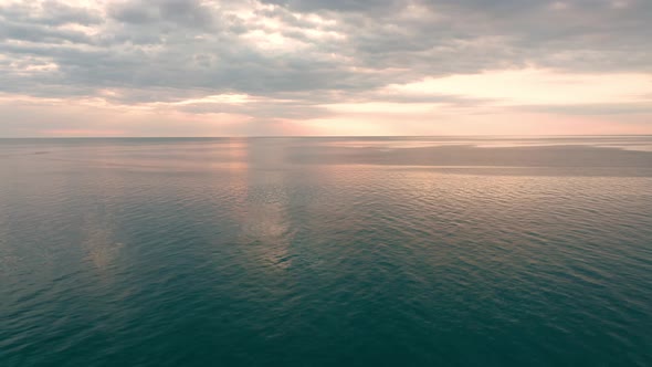 Aerial video over the morning calm sea and beautiful sunrise