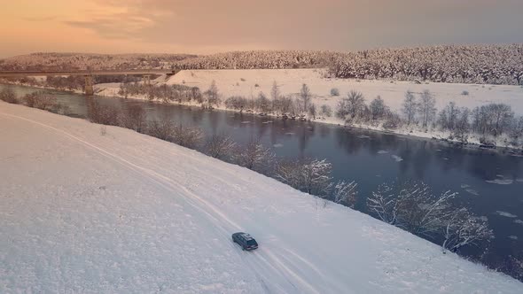 Drone shooting of a river against the background of a forest and a bridge