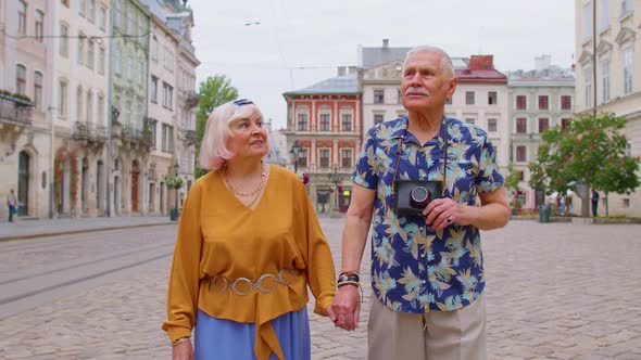 Senior Old Stylish Tourists Man Woman Grandmother Grandfather Family Having a Walk in Summer City