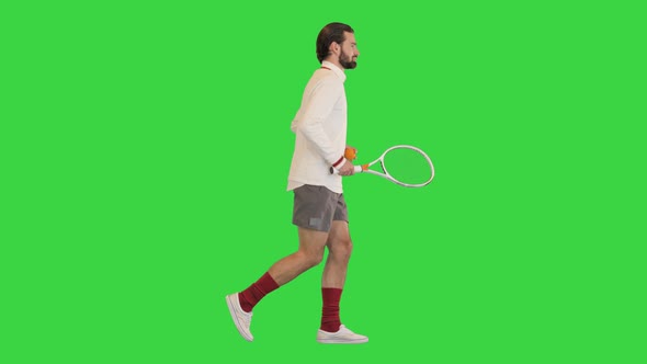 Handsome Tennis Player Running with Tennis Racket on a Green Screen Chroma Key