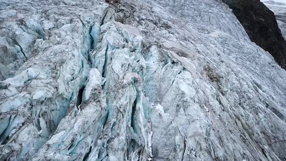Aerial view of a mountain glacier with a lot of craks melting in the Swiss alps