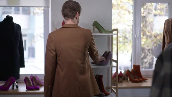 Back View Confident Gay Man Choosing Violet Highheels in Shop Turning Walking Away in Slow Motion