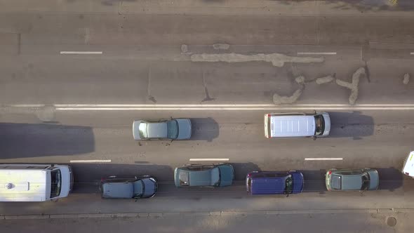 Aerial top down view of busy city street with traffic cars during rush hour.