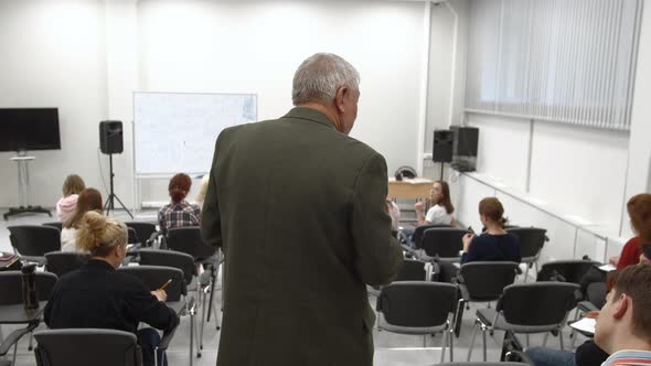 Professor Walks in the Classroom and Gives a Lecture