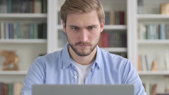 Portrait of Man Working on Laptop