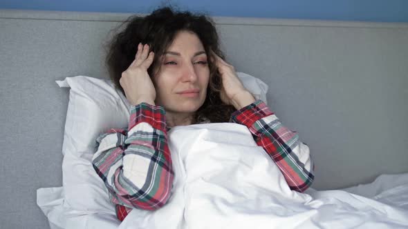 Portrait of a Sick Woman Suffering From Headache