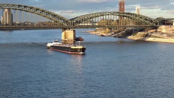 A cargo ship on the River Rhine at Cologne near the  Hohenzollern Bridge. Germany. 2021