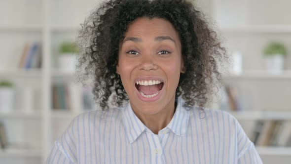 Excited African Woman Celebrating Success