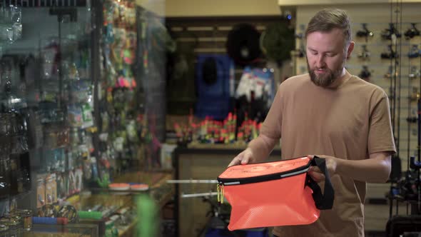 Bearded Man in a Fishing Tackle Shop Getting Ready for a Fishing Trip