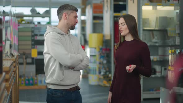 Positive Confident Man and Woman Flirting in Hardware Store