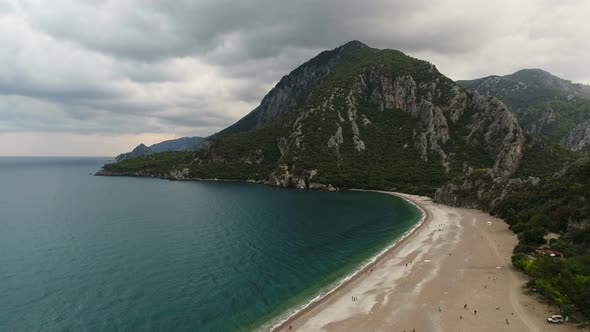 Aerial View of Beach, Sea and Mountain on a Cloudy Day