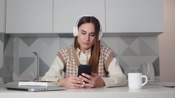 Upset Young Woman Reading a Message on your Mobile Phone