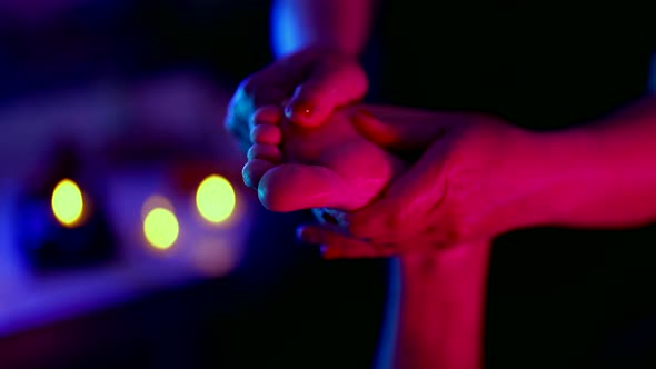 Extreme Closeup of a Female Masseur Hands Massaging the Feet of a Lying Client Fingers a