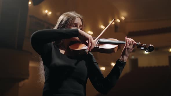 Young Woman Musician is Playing Violin in Music Hall Portrait of Woman with Fiddle