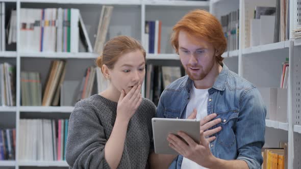 Wondering Team Using Tablet PC  in Shock at Work