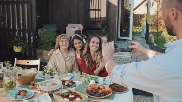 Man Taking Picture of Family Outside