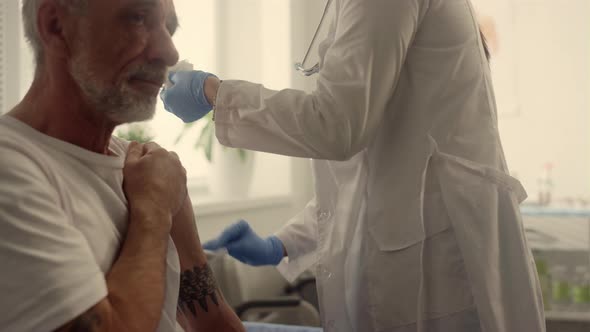 Doctor Hands Injecting Covid Vaccine Old Man Close Up