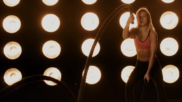 Beautiful Woman Working Out In Front Of A Wall Of Lights