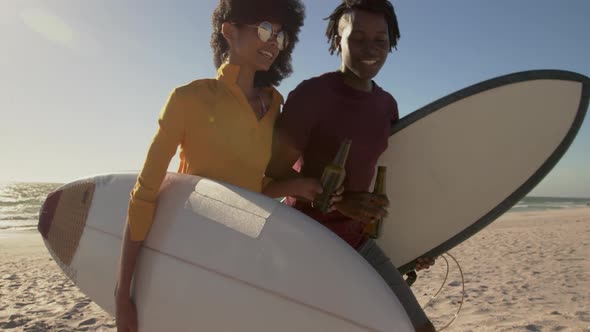 Couple walking together with surfboard on the beach 4k