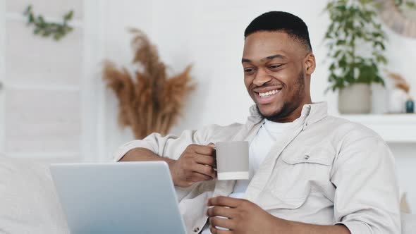 Closeup Male African Student Using Computer for Remote Communication From Home Portrait Afro