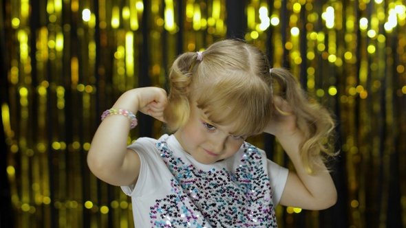 Child Kid Dancing, Celebrating Victory, Fooling Around. Girl Posing on Background with Foil Curtain