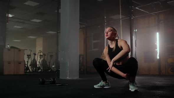 A Young Slender Woman Prepares and Warms Up Before Training