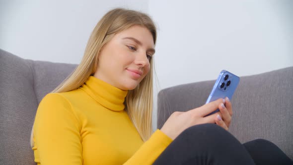 Beautiful blonde girl using smartphone for communication online in 4k stock video