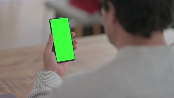 Young Man using Smartphone with Chroma Screen