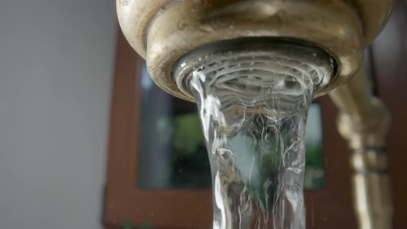 A Stream of Water Flowing From a Faucet in the Kitchen or Bathroom
