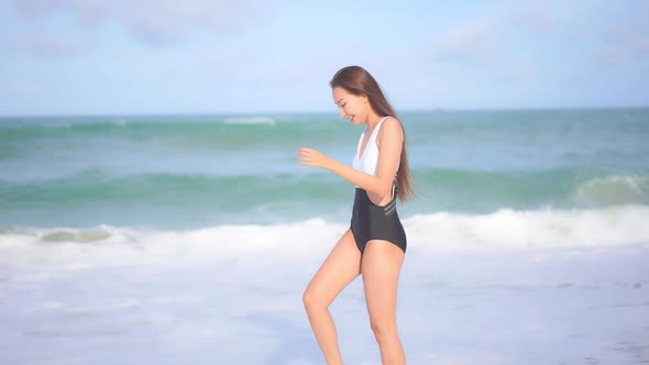 Asian woman enjoy around beautiful beach sea ocean